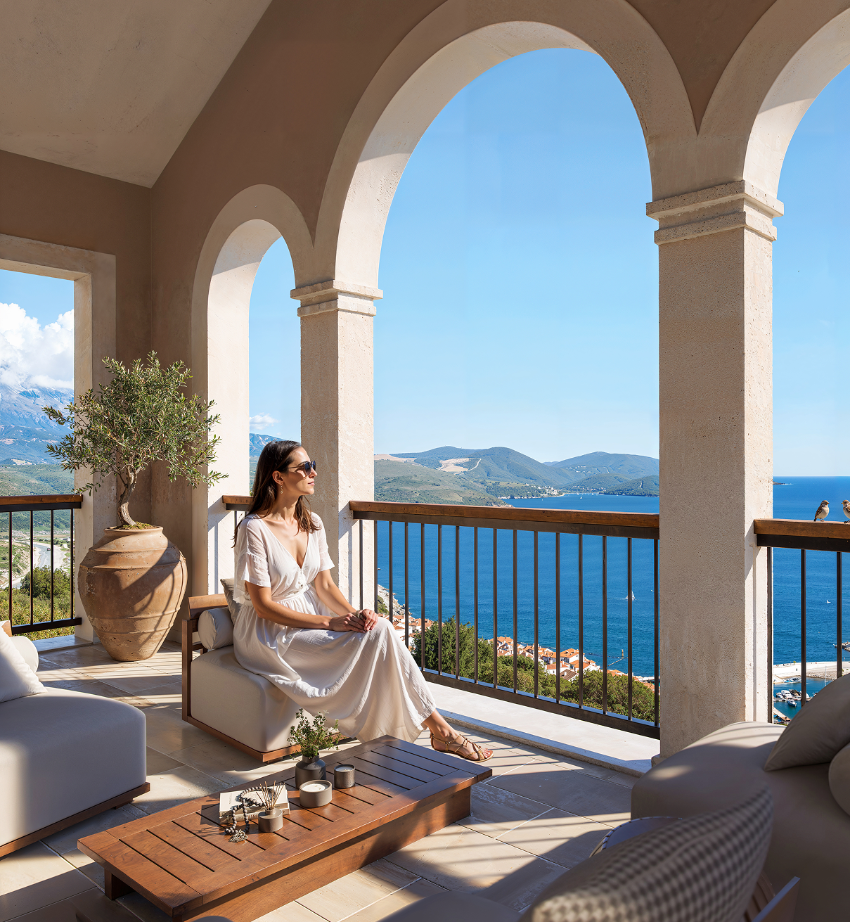 Woman overlooking the Montenegro coast from a stone balcony